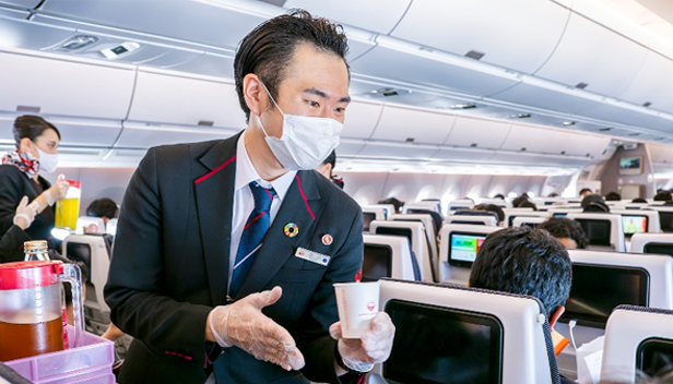 Male cabin attendant in service