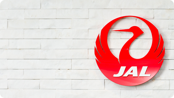 The JAL logo mark hanging on the wall.